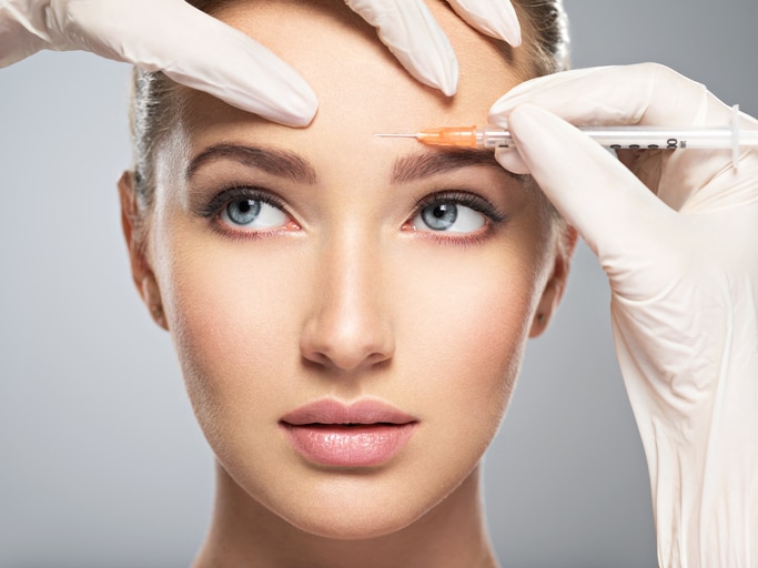 woman receiving Botox injection in forehead