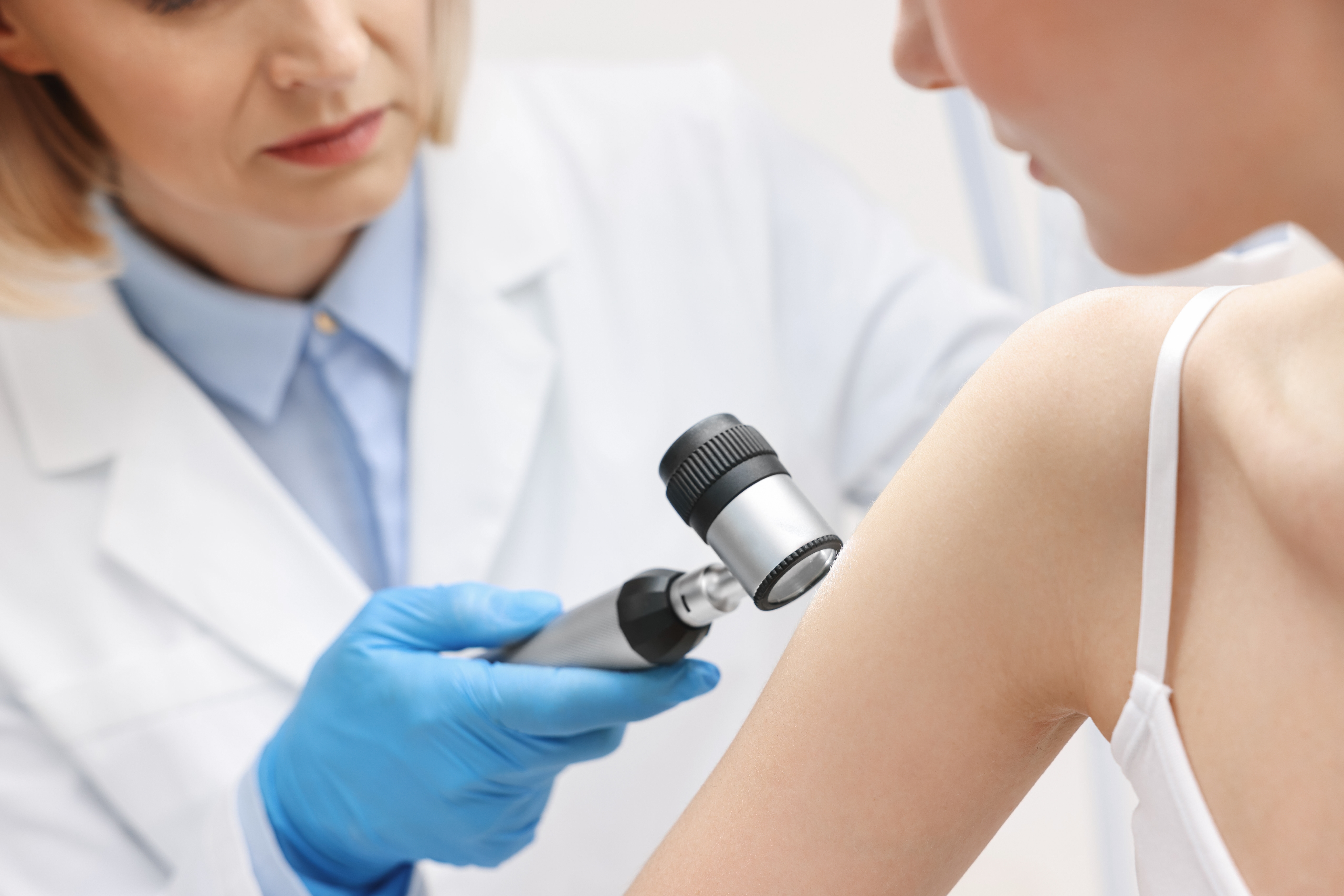 Dermatologist,With,Dermatoscope,Examining,Patient,In,Clinic,,Closeup