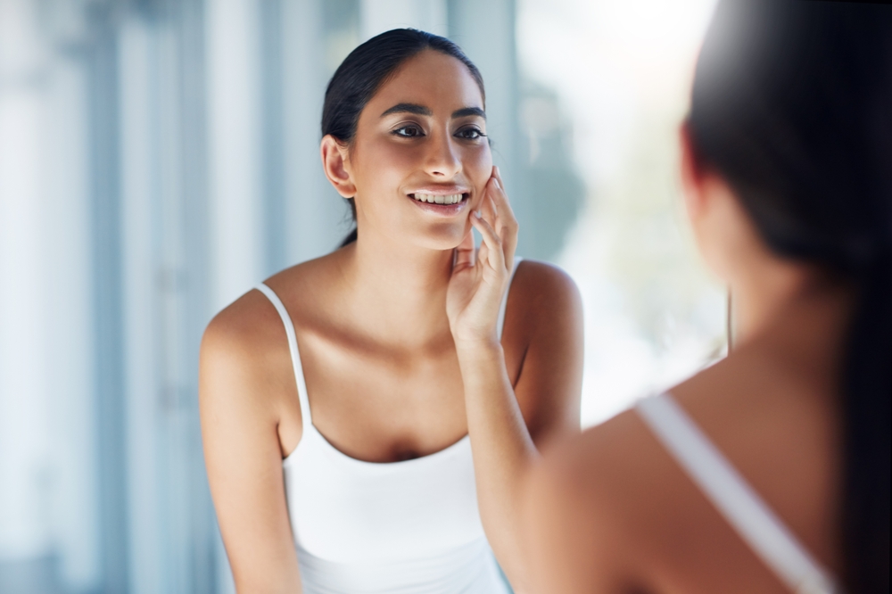 Woman,,Mirror,And,Check,Face,In,Bathroom,For,Skincare,,Results