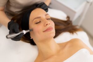A,Skilled,Practitioner,Performs,Microneedling,On,A,Relaxed,Client,,Enhancing