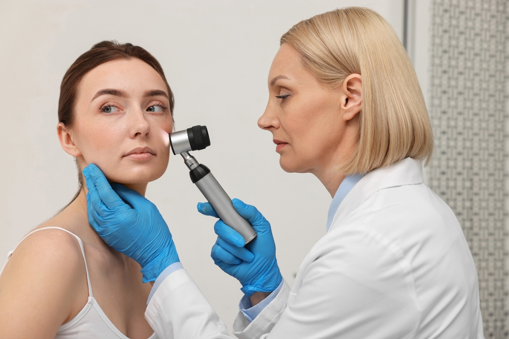 Dermatologist,With,Dermatoscope,Examining,Patient`s,Face,In,Clinic